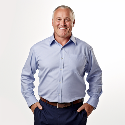 Smiling man wearing a light blue button-down shirt and dark blue slacks